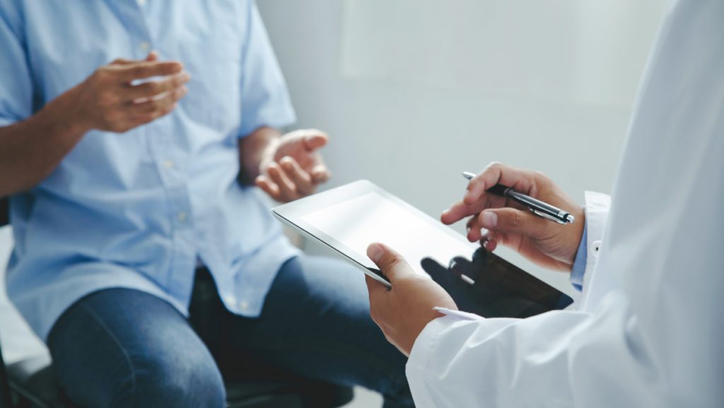 Healthcare provider reviewing clinical research information with a patient